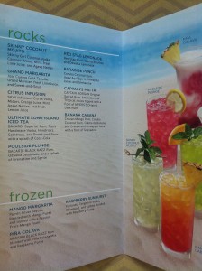 a menu of drinks on a beach