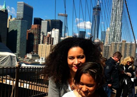 a woman hugging a girl in front of a city