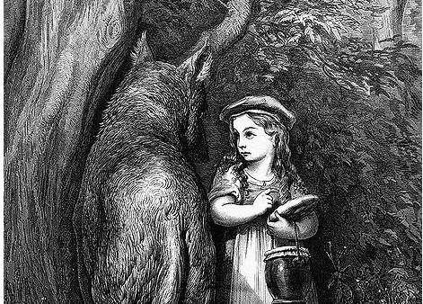 a girl standing next to a wolf
