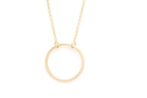 a gold circle necklace on a white background