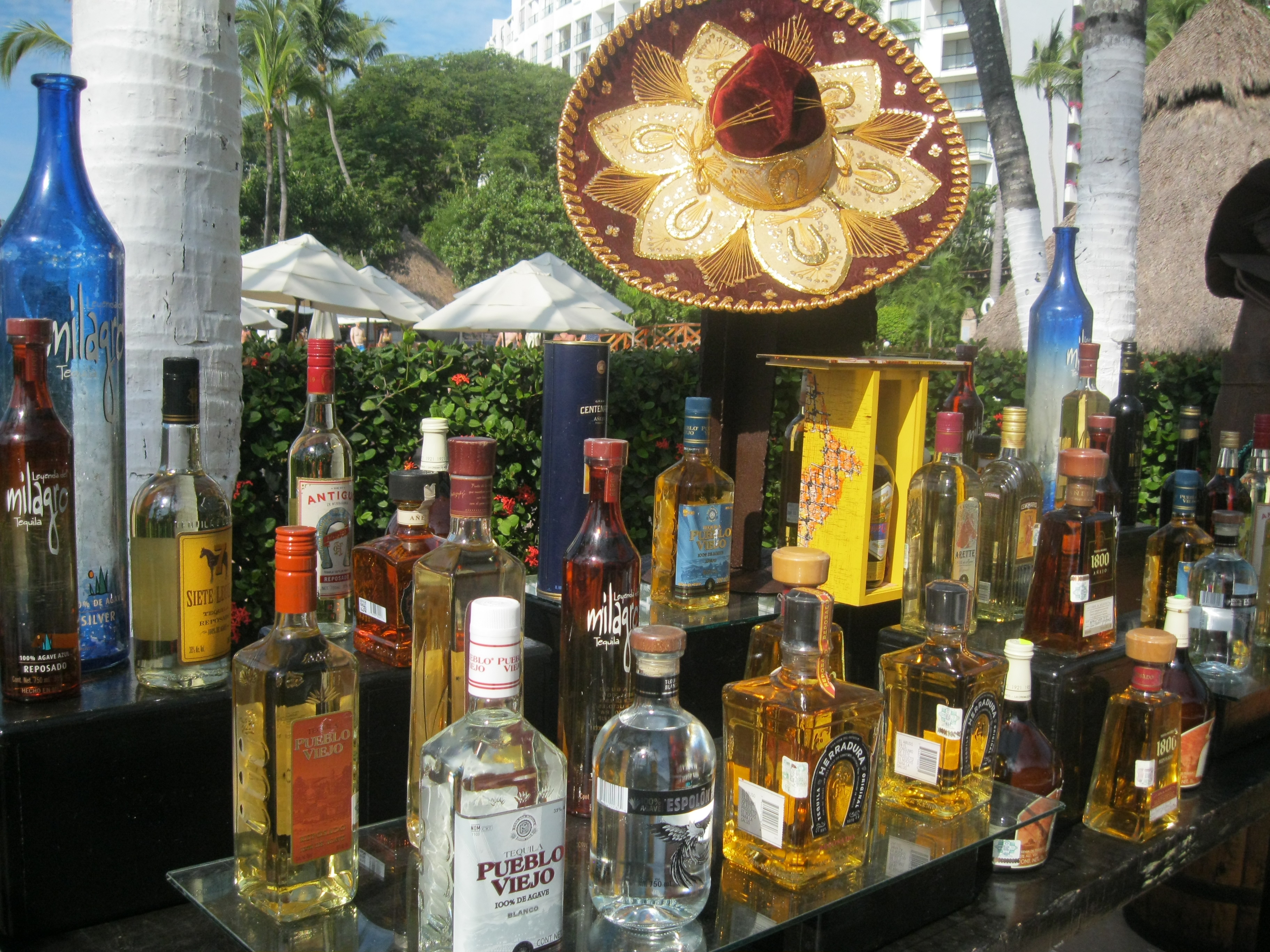 a table with bottles of alcohol and a sombrero