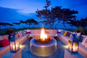 a fire pit with a fire in the middle of a patio