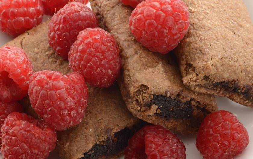 a pile of food with raspberries