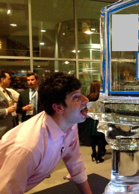 a man licking a water dispenser