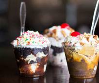 a group of desserts in plastic cups