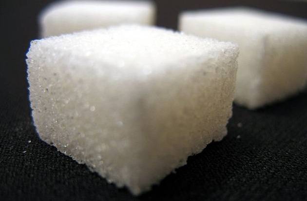 close-up of sugar cubes on a black surface