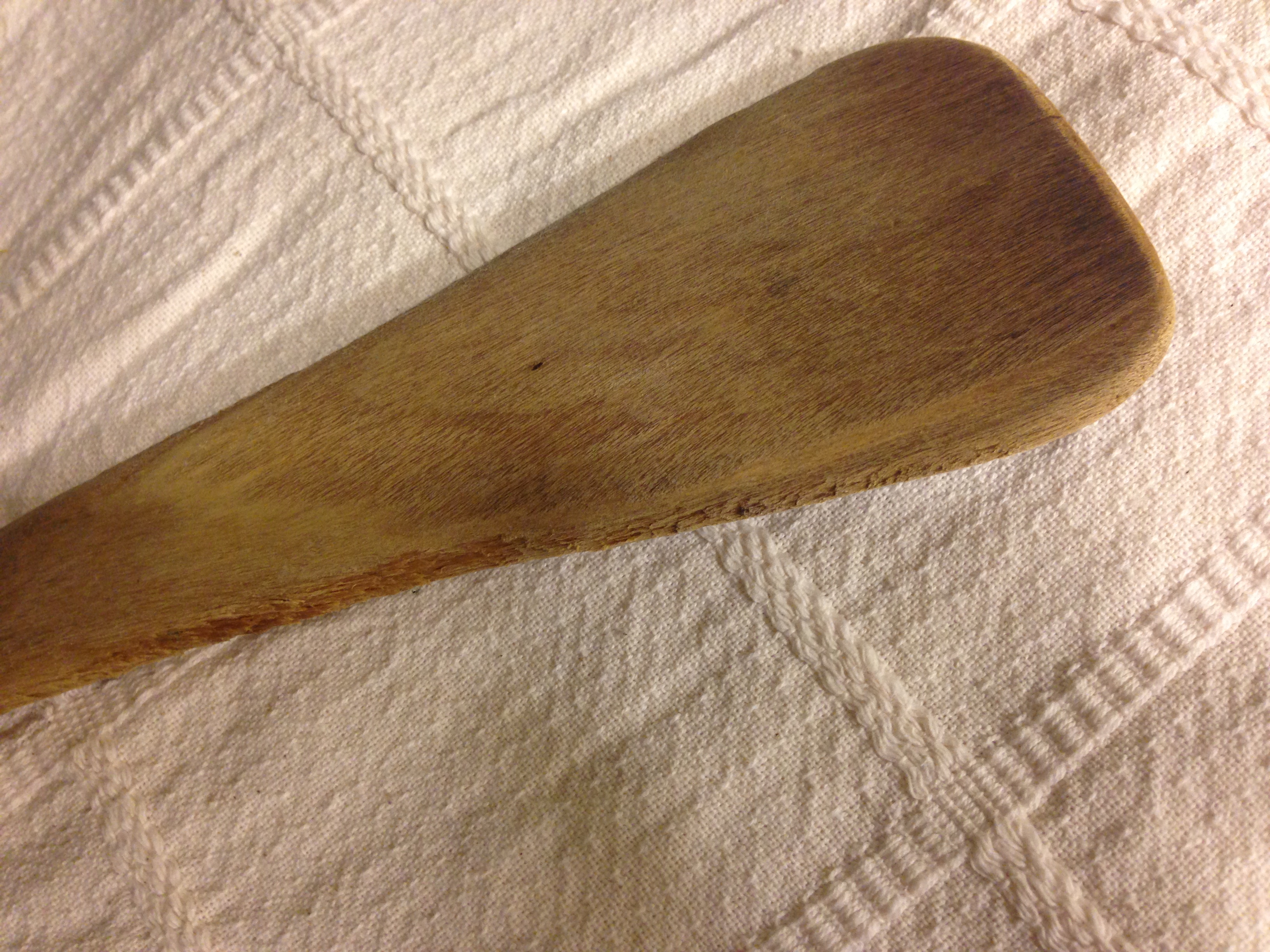 a wooden spoon on a white cloth