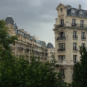 a group of buildings with trees in the background