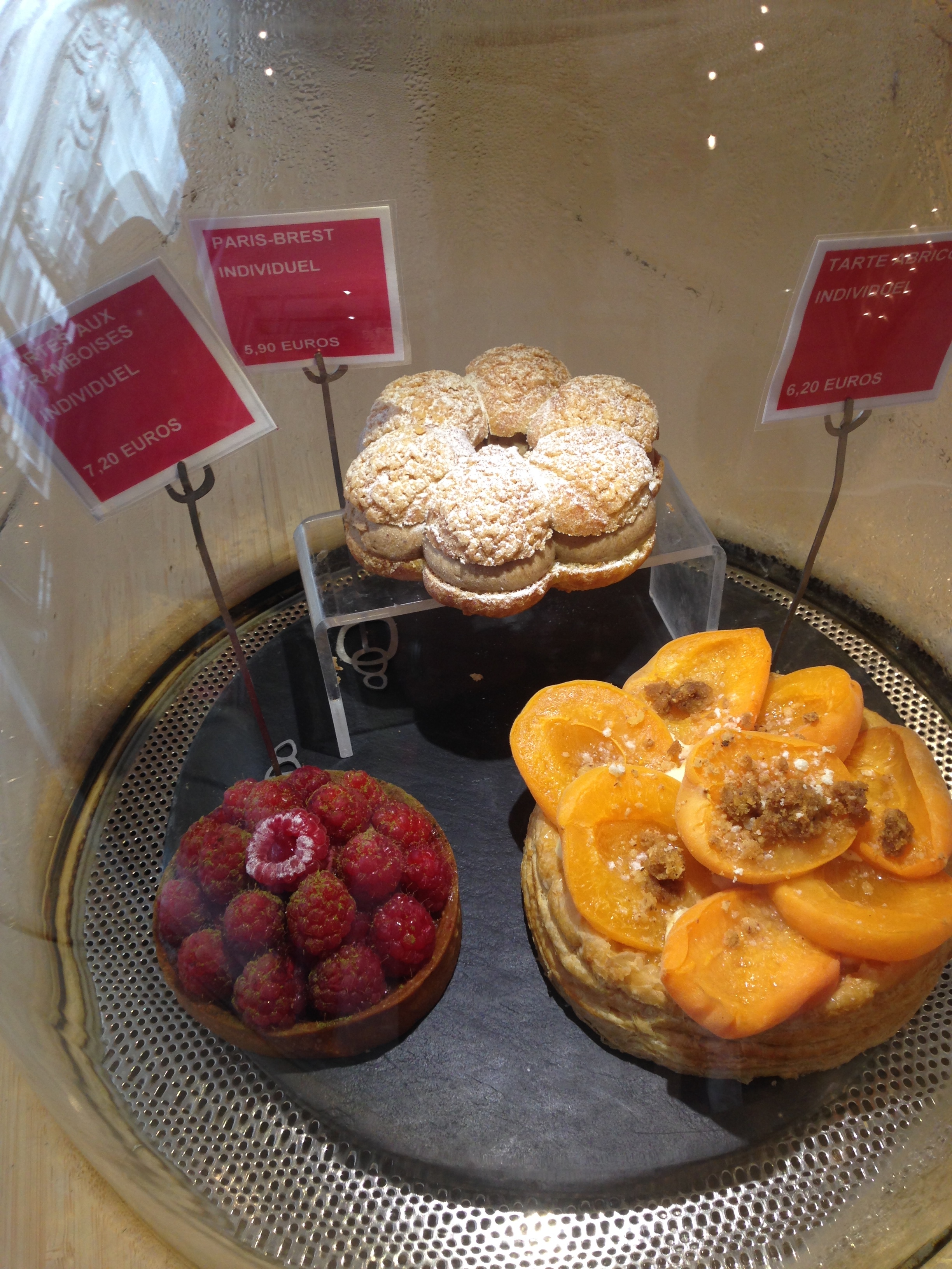 a display case with pastries and fruit