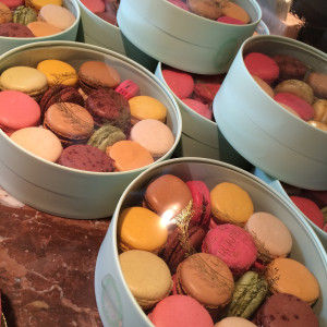 a group of round boxes of colorful macaroons