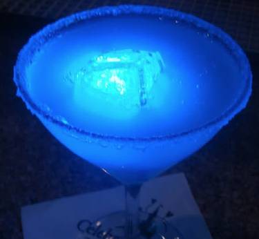 a blue drink with a light in it