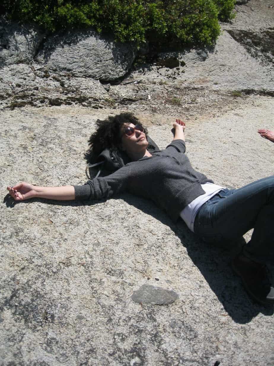 a woman lying on a rock