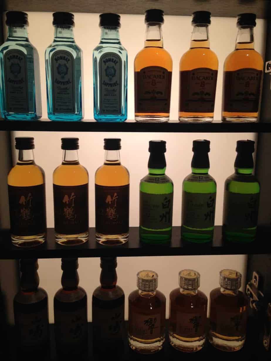 a shelf with bottles of liquor