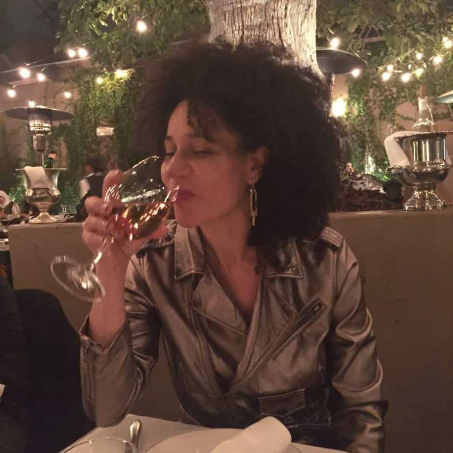 a woman drinking from a wine glass